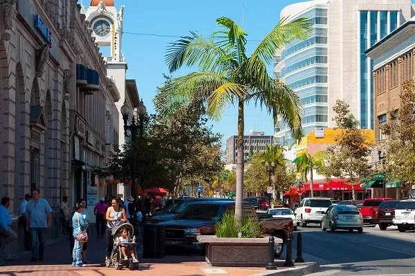 A city street with a clock tower in the background