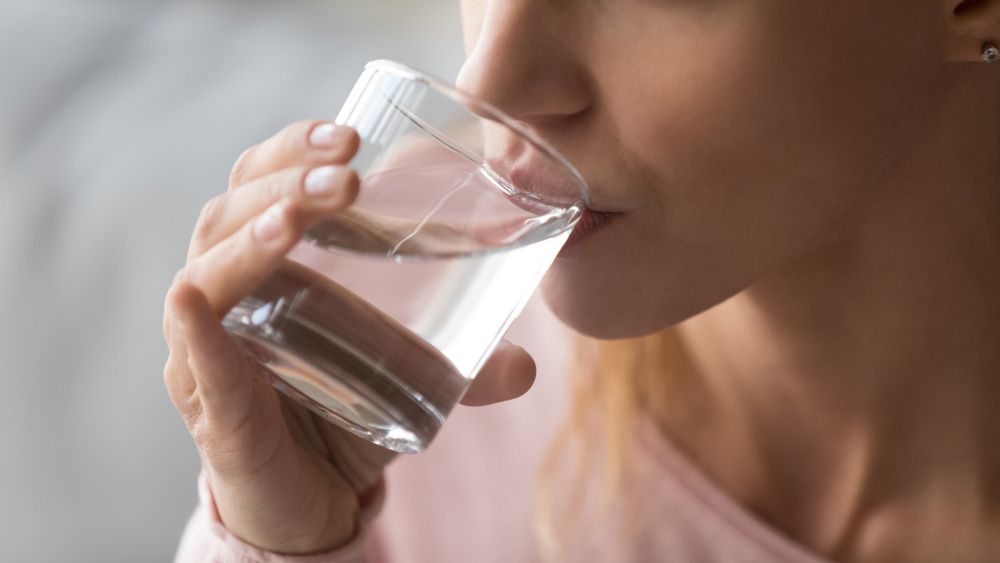 Woman Drinks From a Clear Glass of Water, Close-up — Port Macquarie Pure Water In Laurieton, NSW