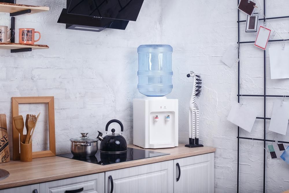 Water Cooler on a Kitchen Counter With a Blue Water Jug — Port Macquarie Pure Water In Wauchope, NSW