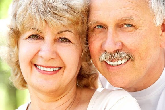 A man and a woman are smiling for the camera.