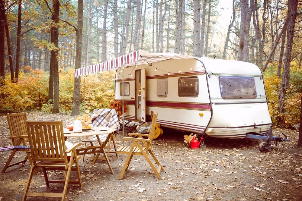 Camper Parked in Woods With Awning Out — Bay & Basin Storage In Huskisson, NSW