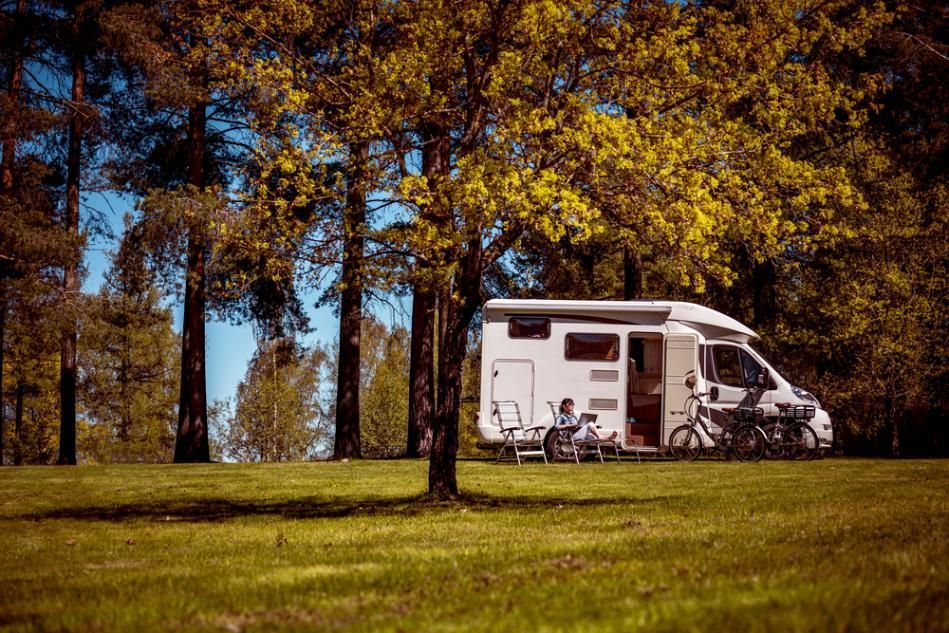 White RV Parked in a Grassy Field — Bay & Basin Storage In Nowra, NSW