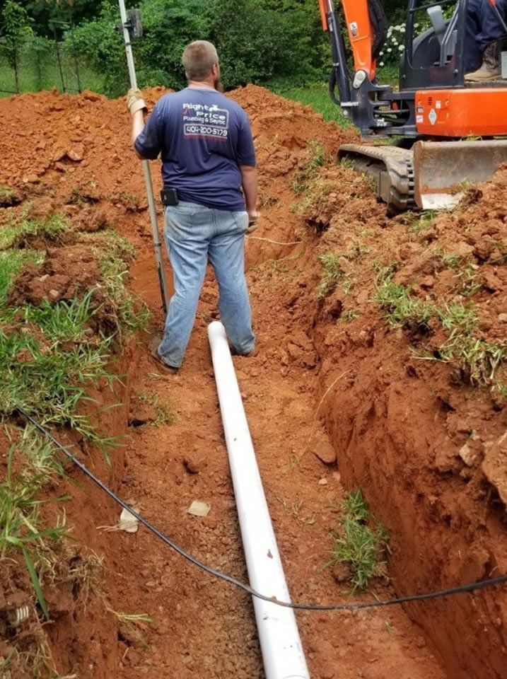 Worker Installing a White Pipe — Monroe, GA — Right Price Plumbing and Septic