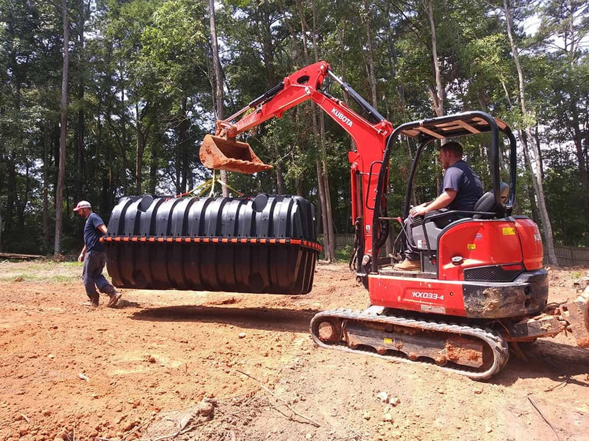 Excavator Lifting a Septic tank — Monroe, GA — Right Price Plumbing and Septic
