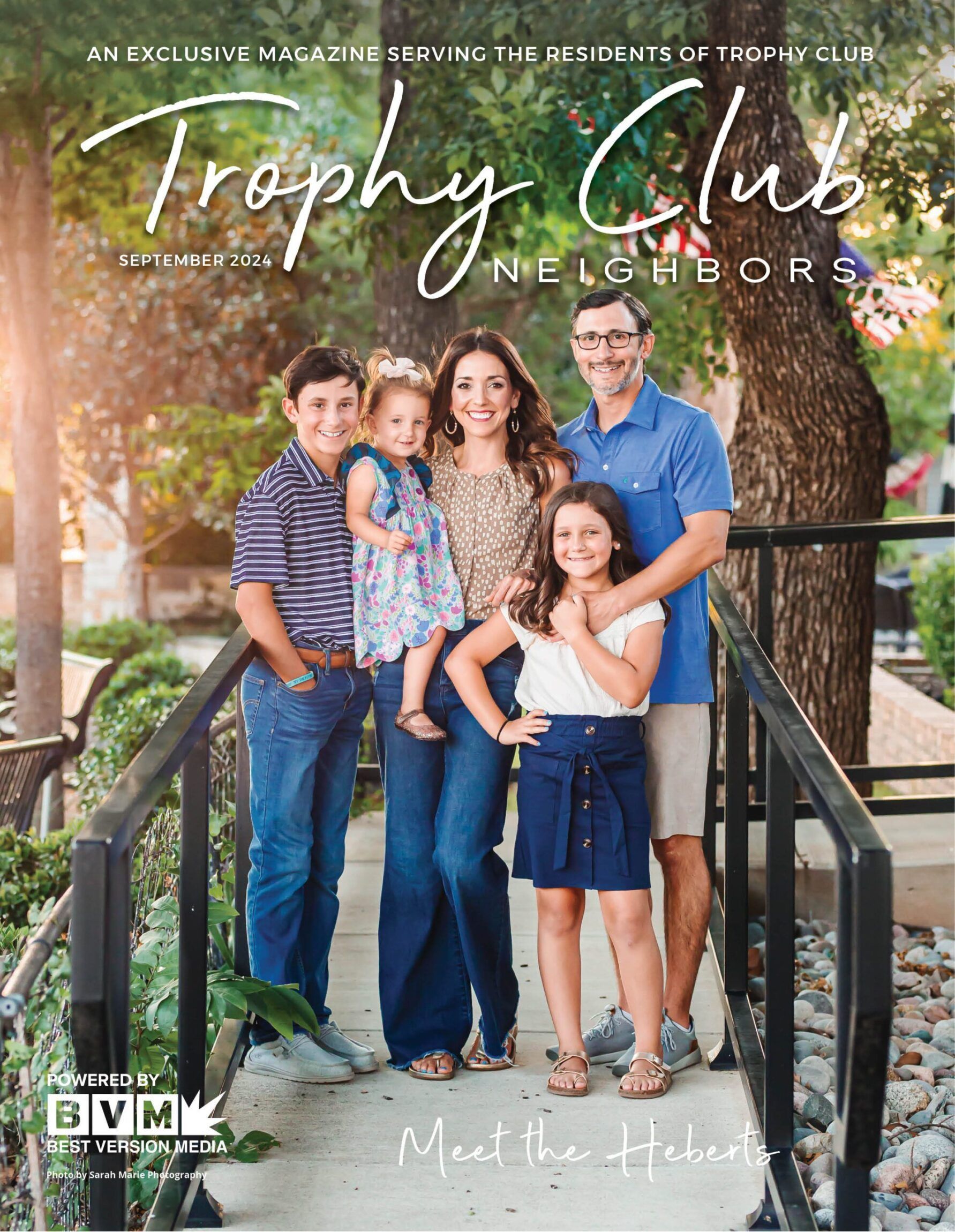 A family stands together on a bridge, smiling for a portrait featured on the cover of Trophy Club Neighbors magazine.