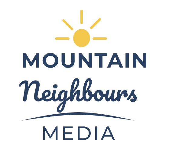 Logo for Mountain Neighbours Media with a yellow sun icon above text in blue, featuring a slight wave underline.