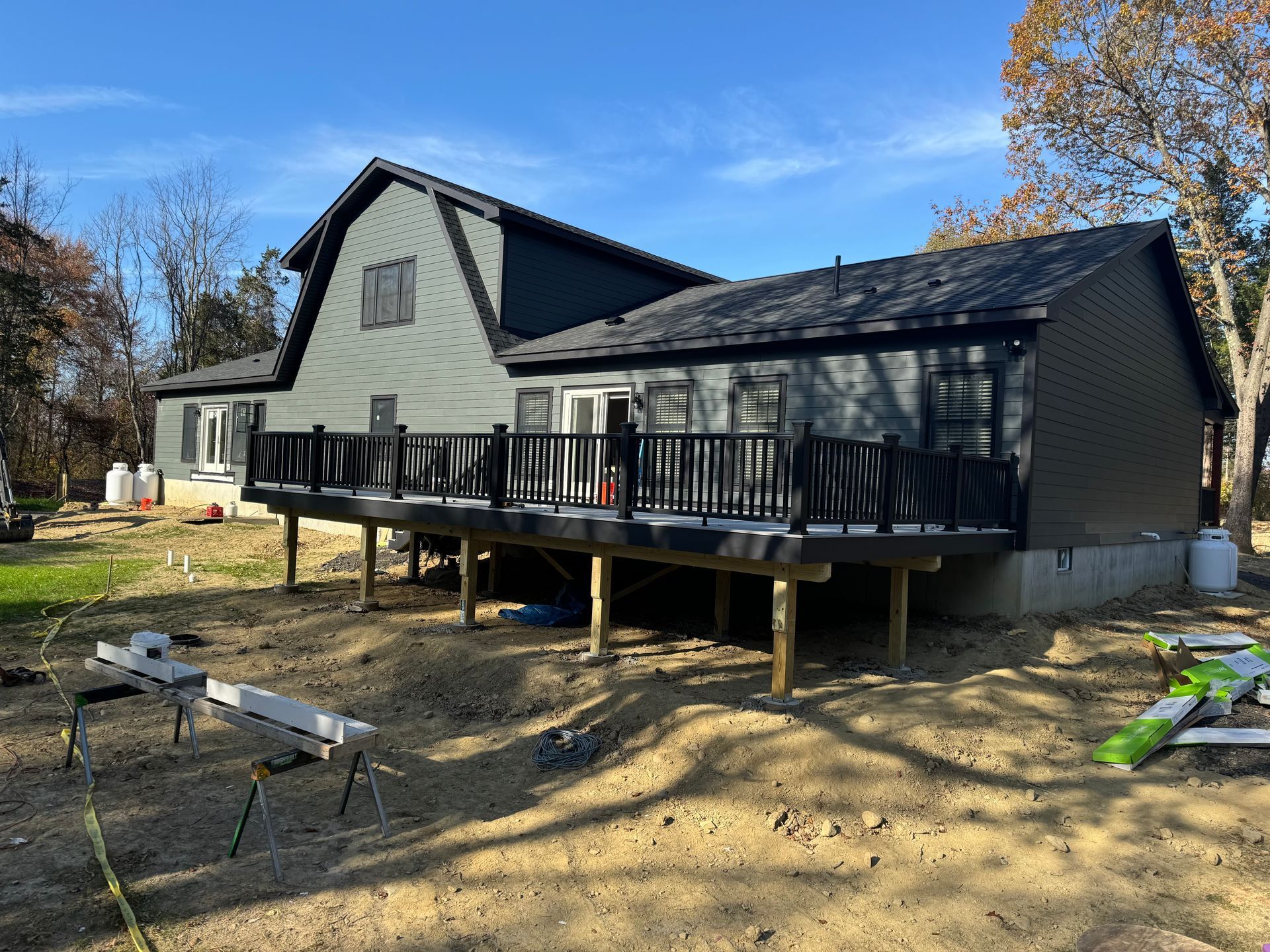 A house with a large deck is being built on stilts.
