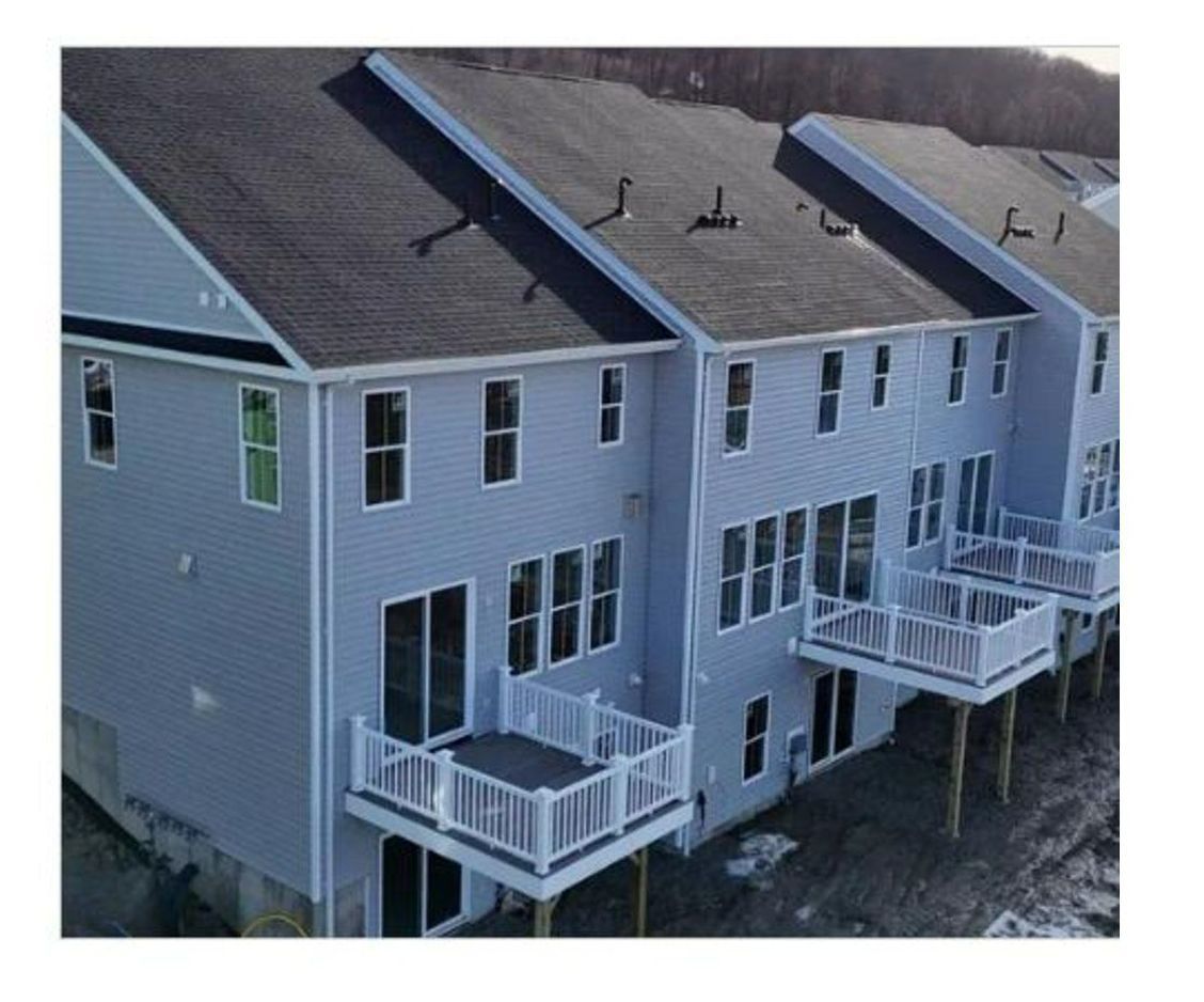 A large building with a wooden deck in front of it.