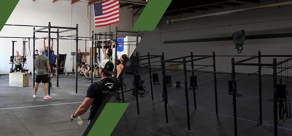 A group of people are doing exercises in a gym with an american flag hanging from the ceiling.