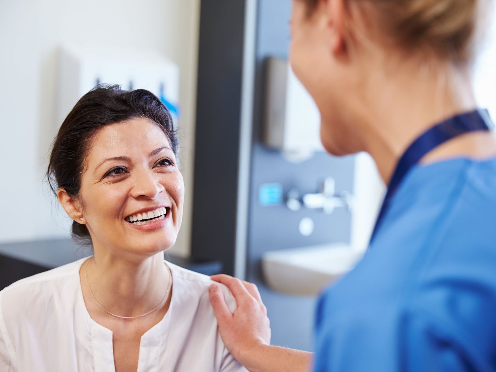 Nurse talking to middle aged patient