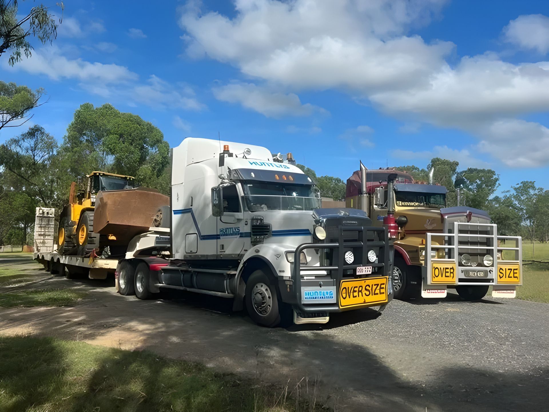 Oversize Trucks Transporting Machinery  — Huntlys Heavy Equipment in Gracemere, QLD