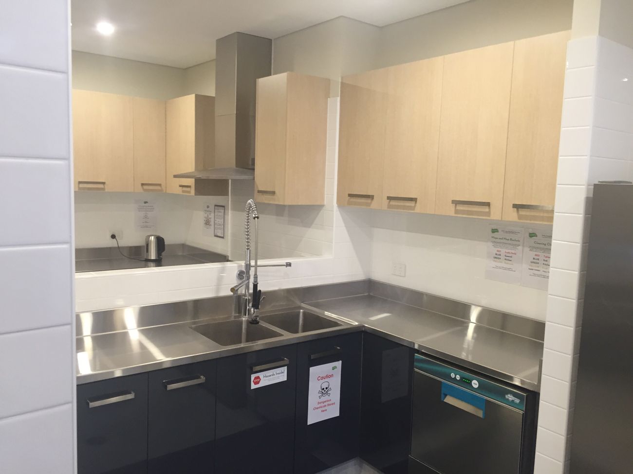 A kitchen with stainless steel appliances and wooden cabinets