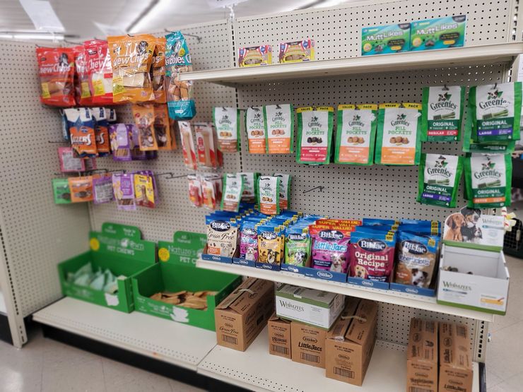 a store shelf with a display of greenies dog treats