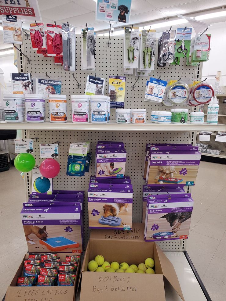 a display of pet supplies including a box of tennis balls