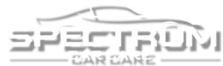 A logo for spectrum car care with a car on it.