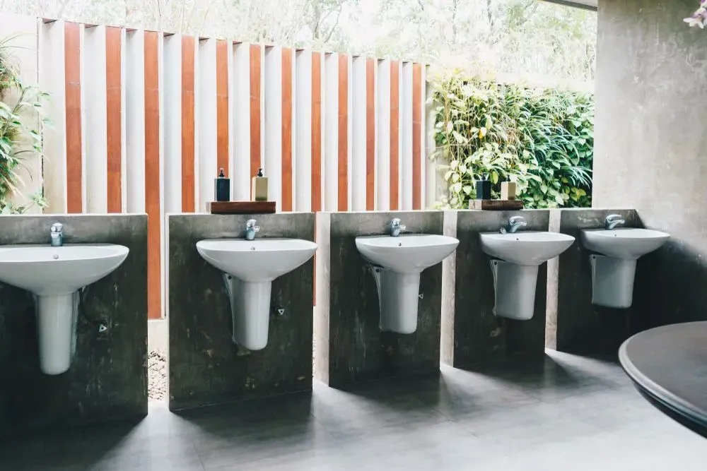 A Bathroom with A Row of Sinks Lined up Next to Each Other — Medowie Plumbing & Gas In Medowie, NSW