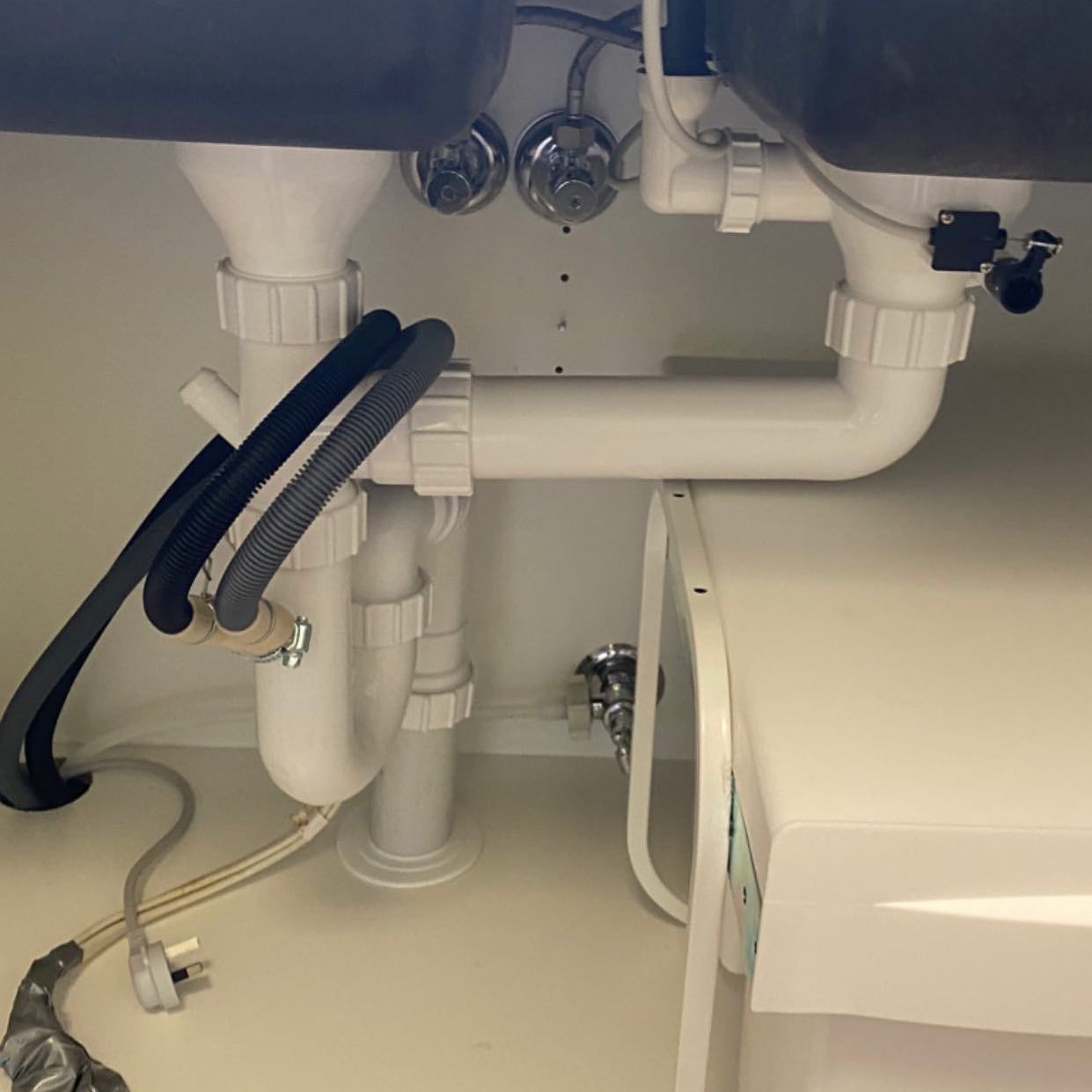 A Bathroom Vanity with Two Sinks and Drainage Underneath It — Medowie Plumbing & Gas In Medowie, NSW