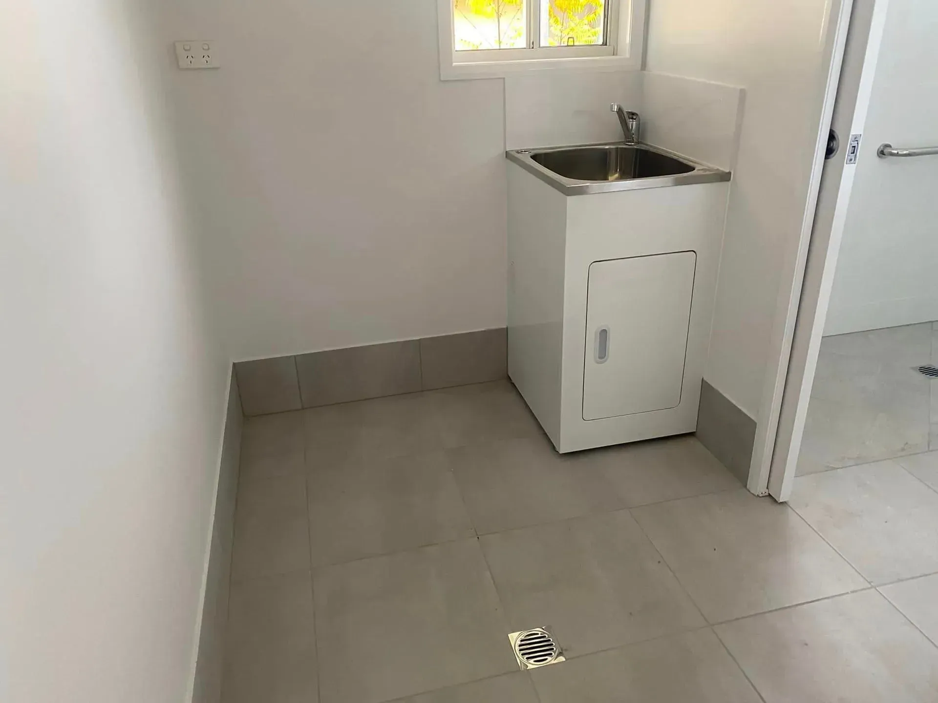 A Laundry Room with A Sink and Dryer in It — Medowie Plumbing & Gas In Medowie, NSW