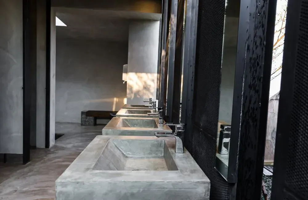 A Bathroom with A Row of Concrete Sinks and Mirrors — Medowie Plumbing & Gas In Medowie, NSW