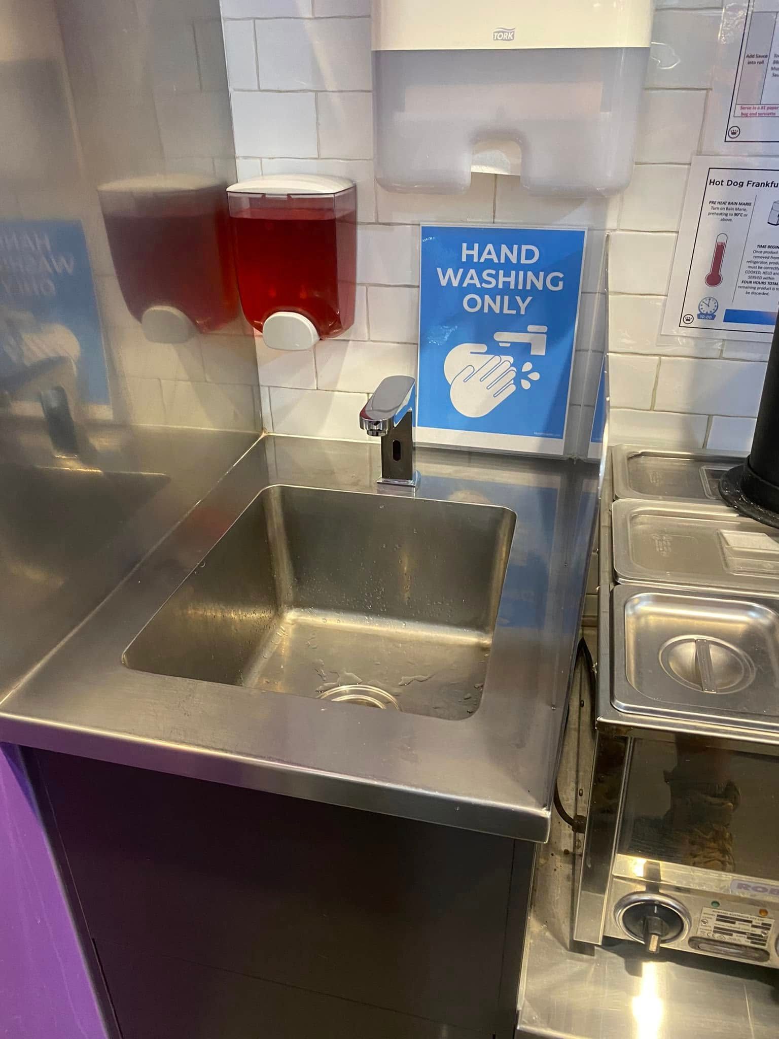 Stainless Steel Sink With Soap Dispenser in a Commercial Kitchen Area — Medowie Plumbing & Gas in in Newcastle