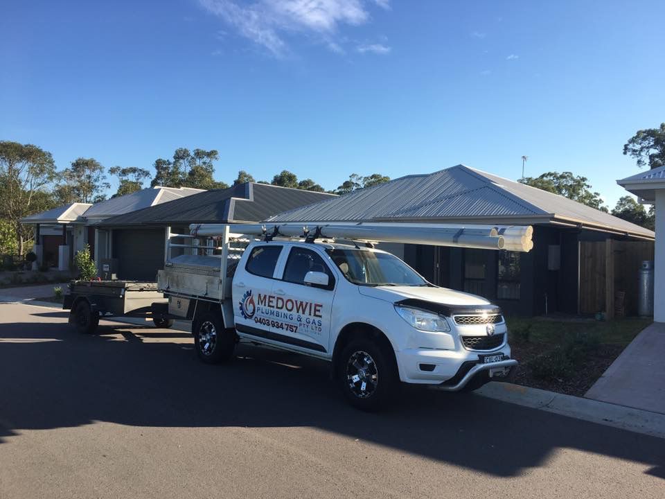 A White Truck Is Parked in Front of A House — Medowie Plumbing & Gas In Medowie, NSW