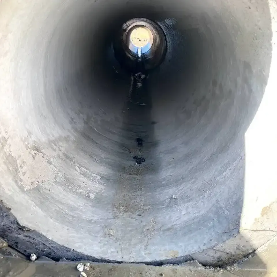 The Inside of A Concrete Pipe with Water Coming out Of It — Medowie Plumbing & Gas In Medowie, NSW