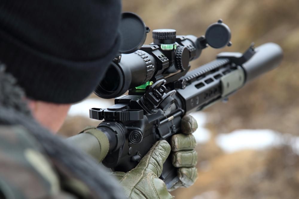A Man Aims a Rifle, Focused Intently 	— Coffs Coast Firearms In Grafton, NSW