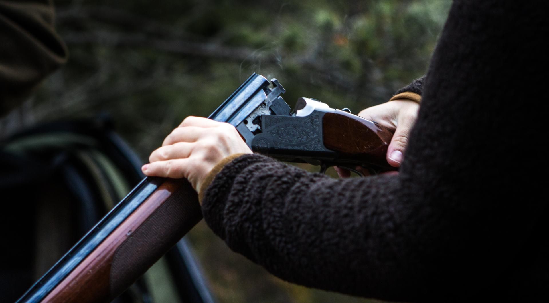 A Person in the Foreground Holds a Shotgun — Coffs Coast Firearms In Kempsey, NSW