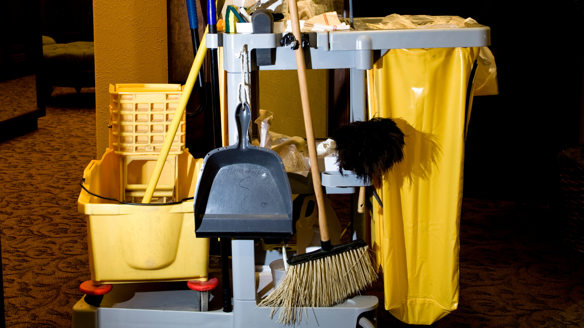 A cleaning cart with a yellow bag on it