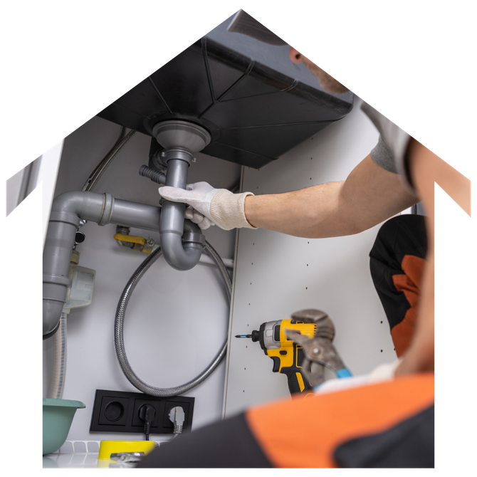 A man is fixing a sink with a drill.