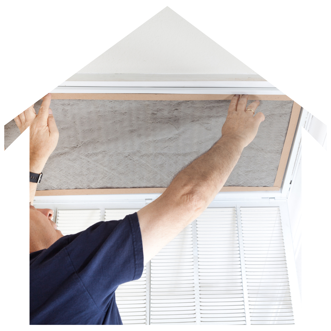 A man is fixing an air filter in a house.