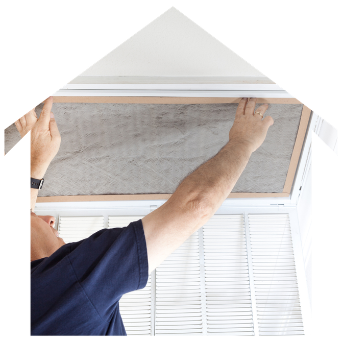 A man is fixing an air filter in a house.