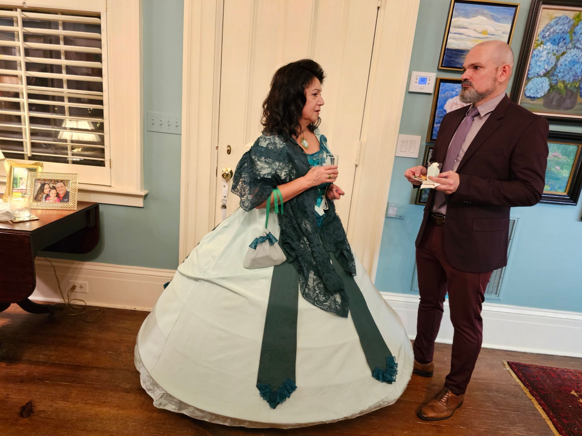 A woman in a dress is standing next to a man in a suit.