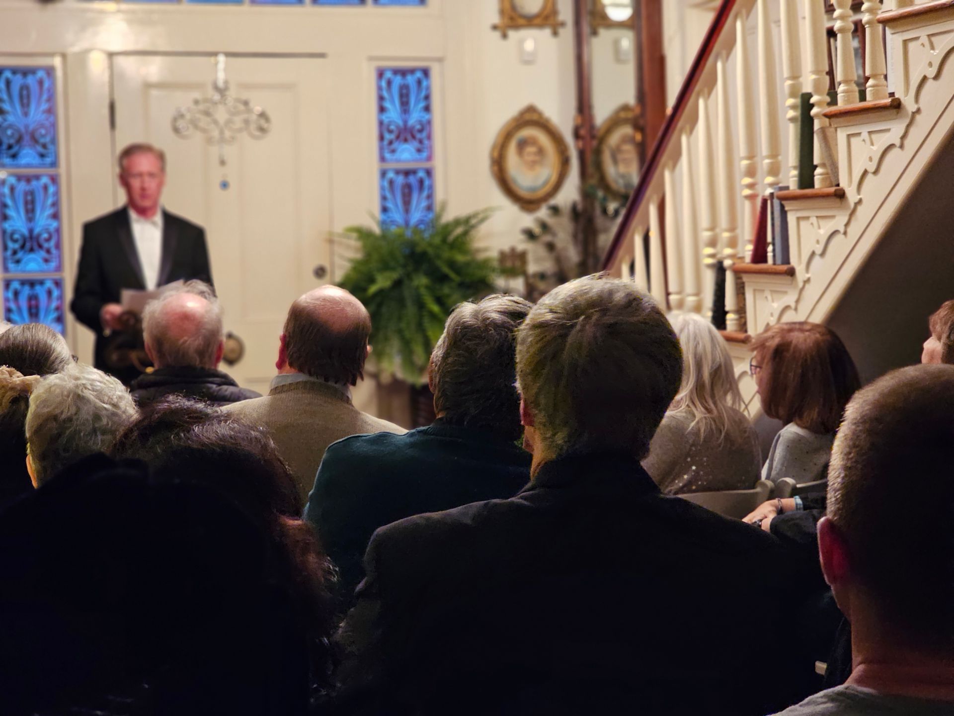 A man is giving a speech in front of a crowd of people