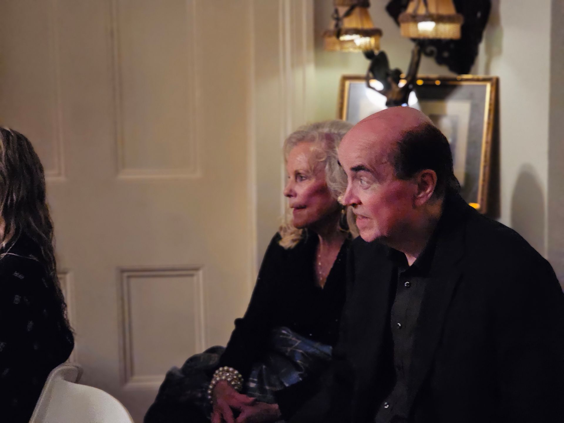 A man and a woman are sitting next to each other in a room