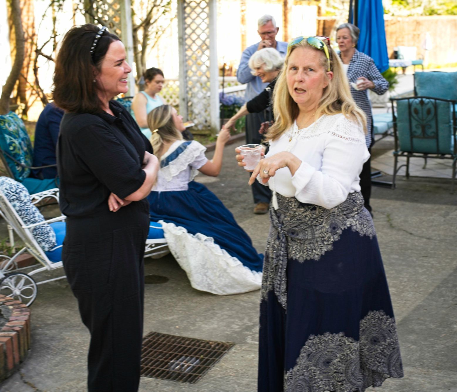Two women are standing next to each other and talking