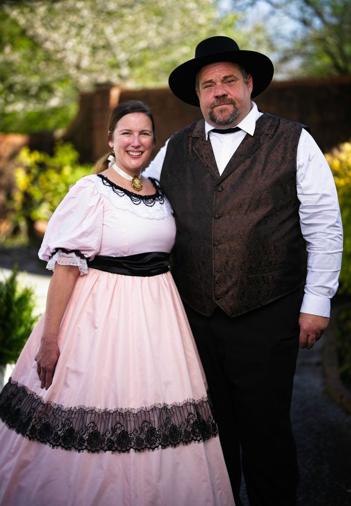 A man and a woman in historical costumes are posing for a picture.