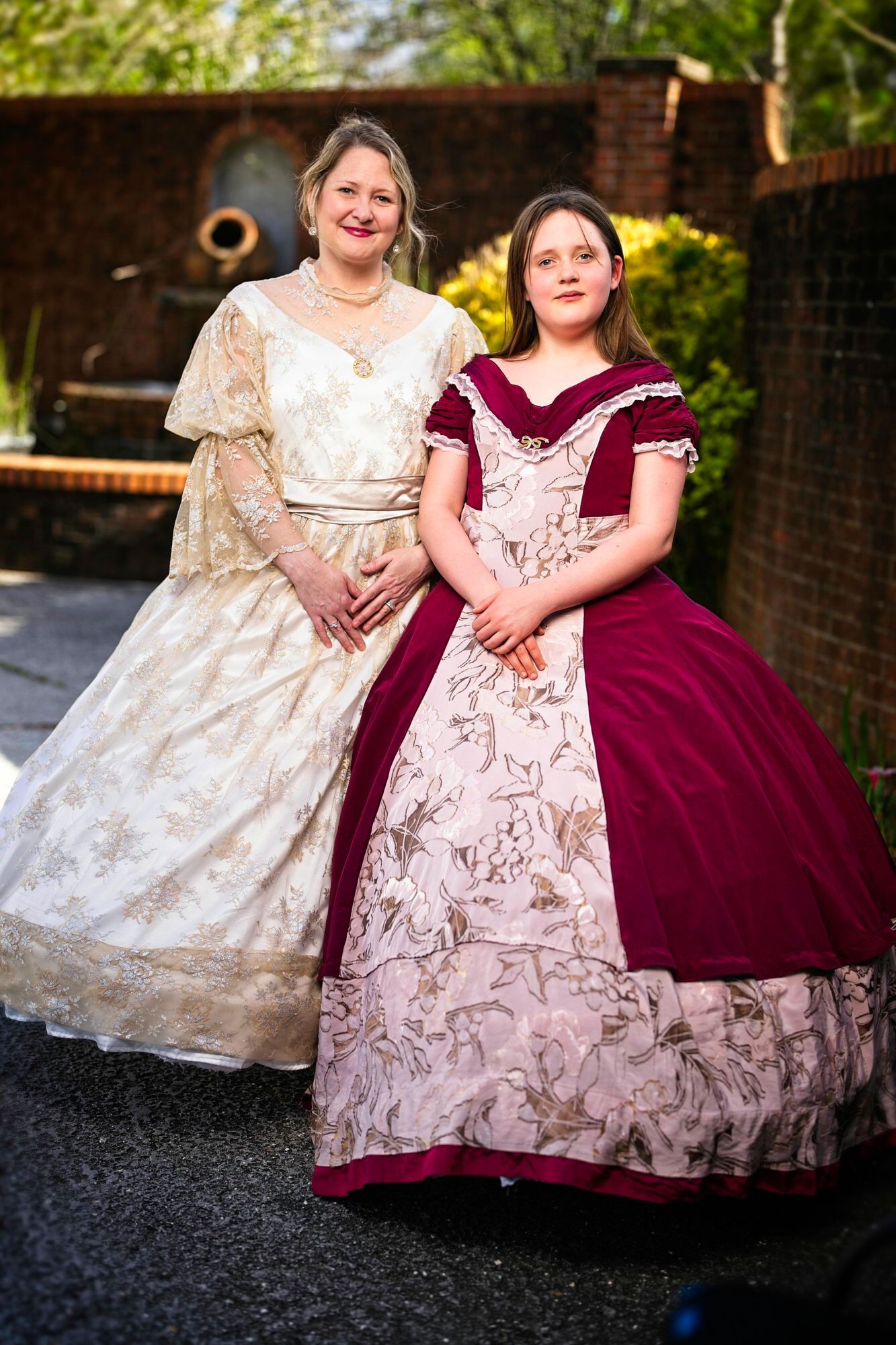 Two women in historical dresses are standing next to each other.