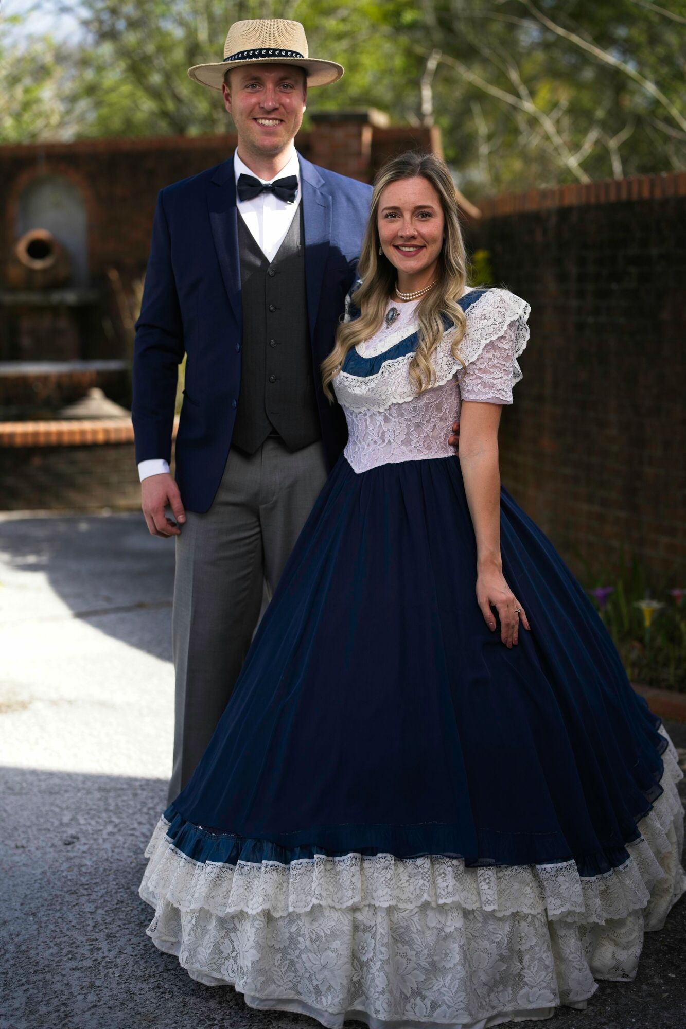 A man and a woman in historical costumes are posing for a picture.
