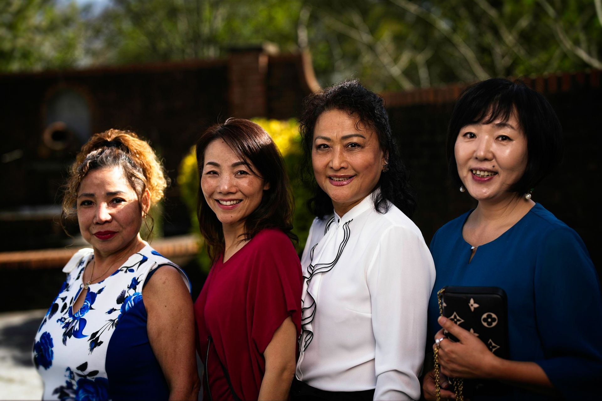A group of four women are posing for a picture together.