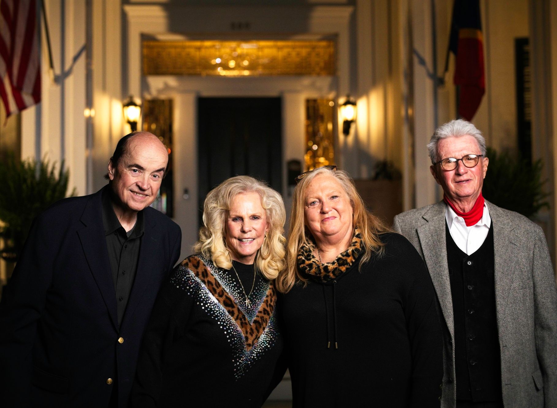 A group of people are posing for a picture in front of a building.