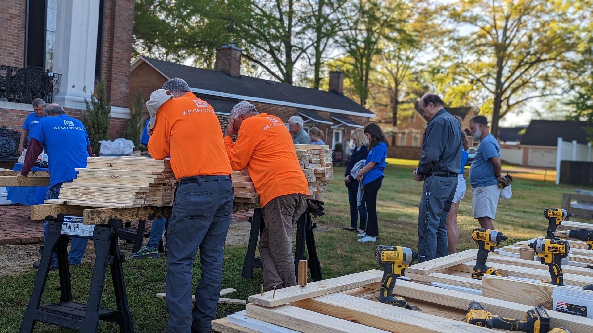 A group of people are working on a wooden structure.