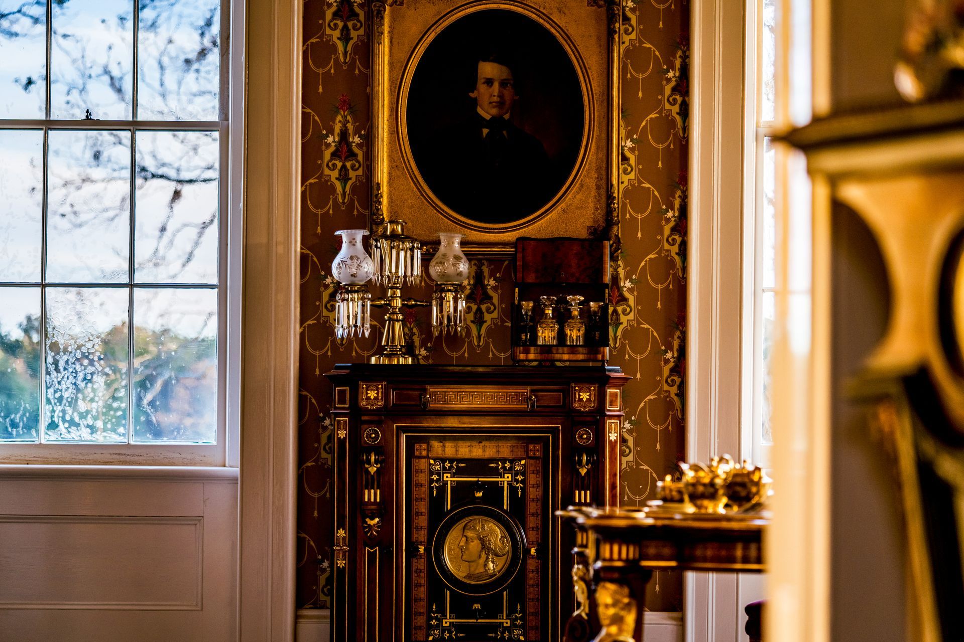 A room with a fireplace and a painting on the wall.