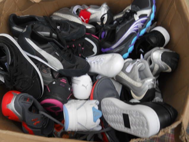 A pile of shoes including a pair of pumas