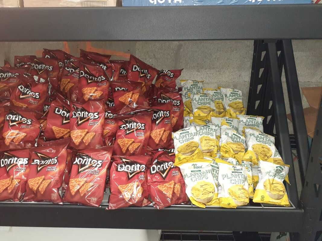 A shelf filled with bags of doritos chips in a store.