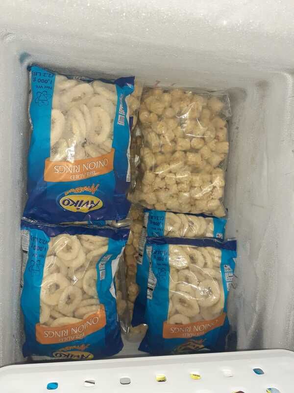A freezer filled with bags of macaroni and cheese.