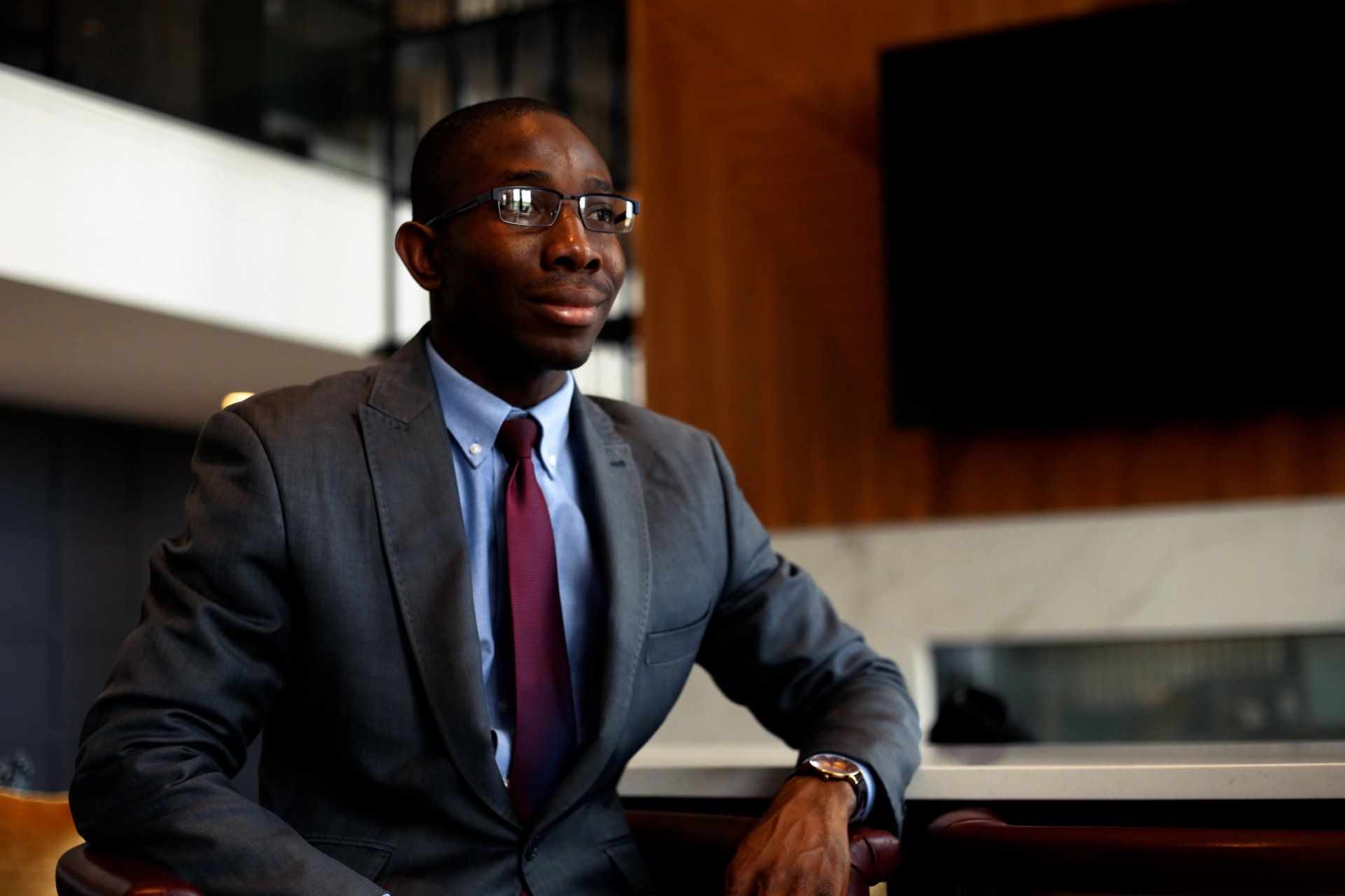 A man in a suit and tie is sitting at a table.