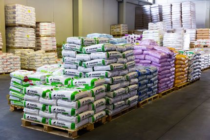 A warehouse filled with lots of bags and pallets.