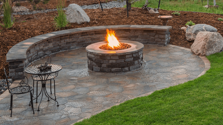 an outdoor firepit with masonry features