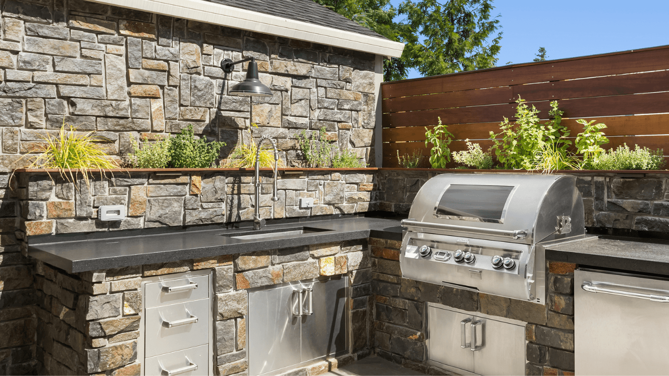 an outdoor kitchen with stone veneer finish